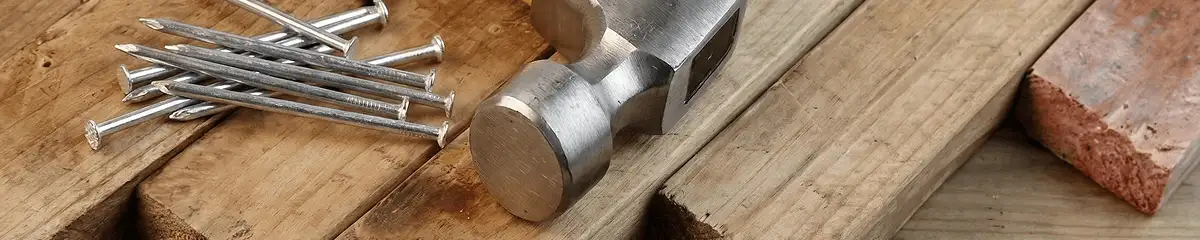 Hammer and nails on hardwood flooring boards in Manchester, NH