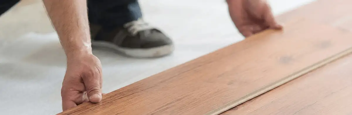 A professional installing laminate flooring in Manchester, NH