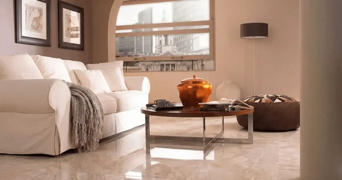 Modern living room with professionally installed marble flooring, a beige sofa, coffee table in Manchester, NH