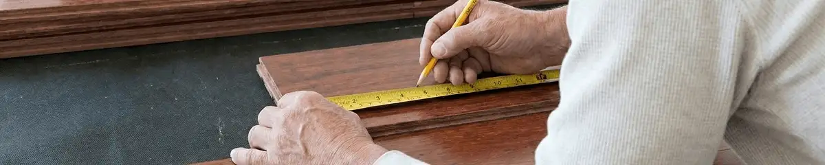 A professional installing wood flooring in Manchester, NH